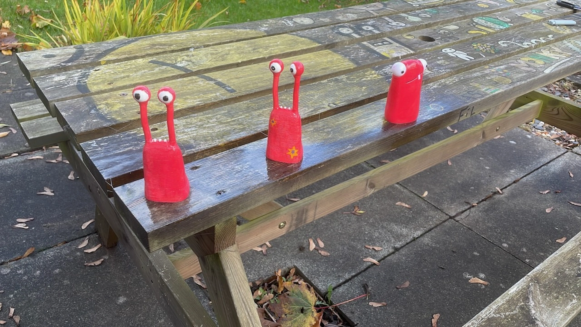 Three Derek figures on a bench